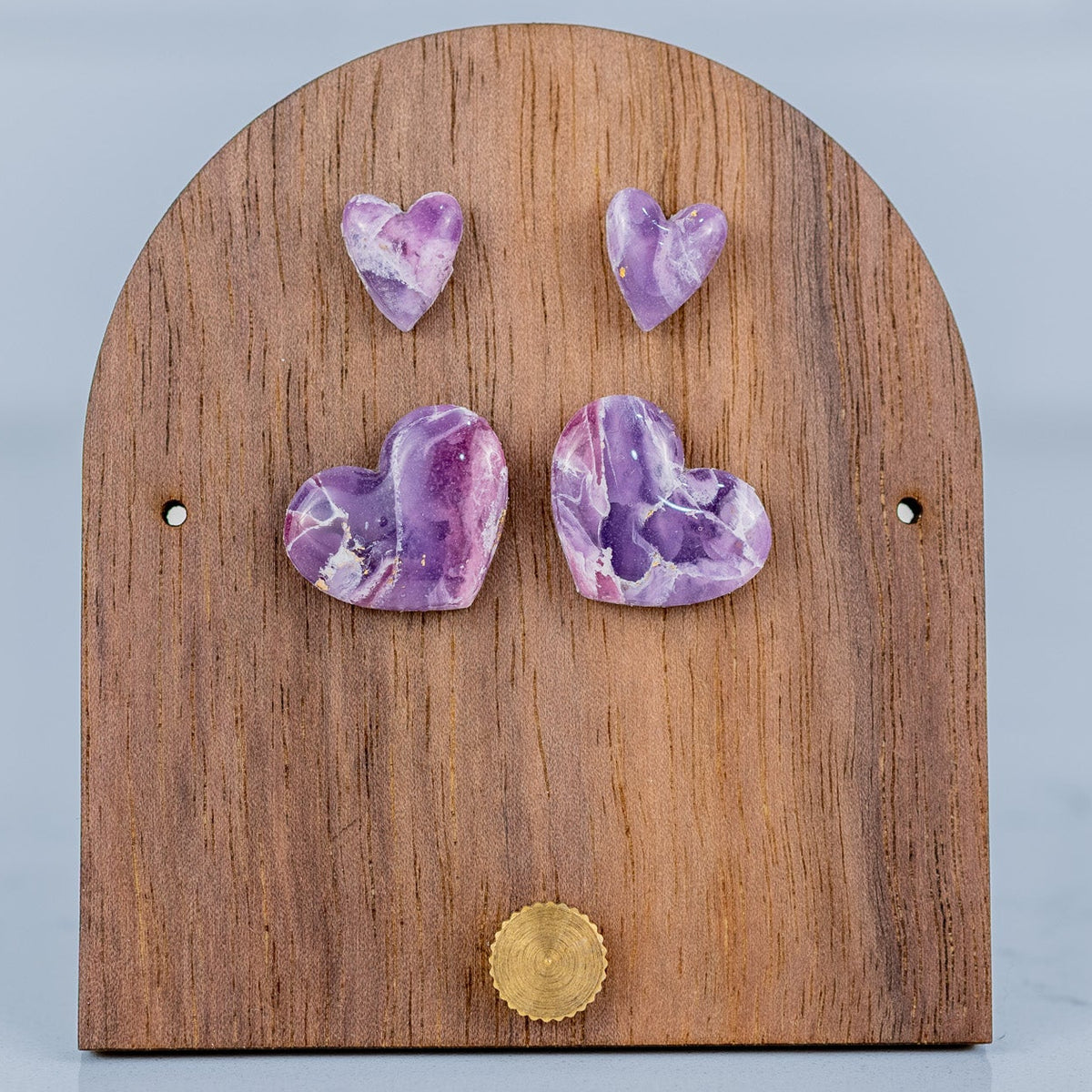 Wooden earring stand with purple heart-shaped earrings