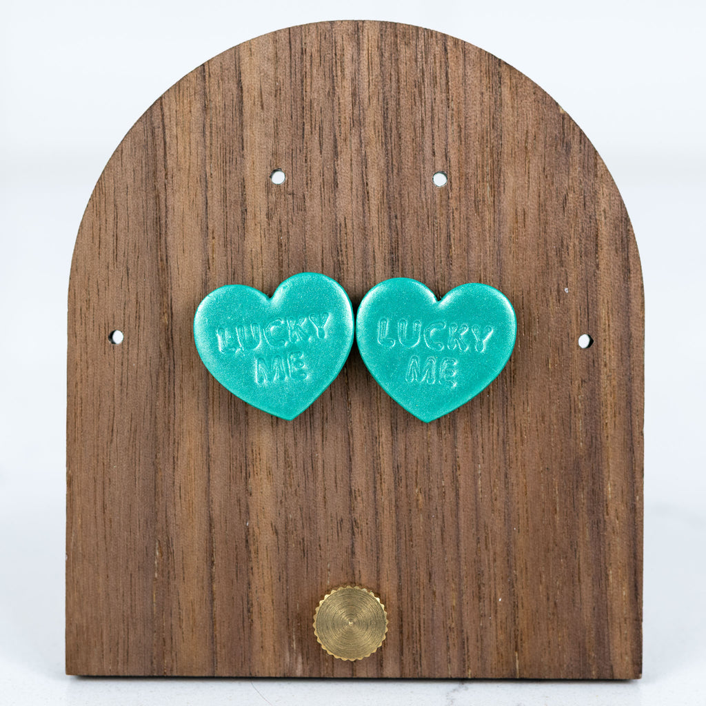 Teal lucky me heart stud earrings with embossed lettering
