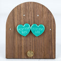 Teal lucky me heart stud earrings with embossed lettering