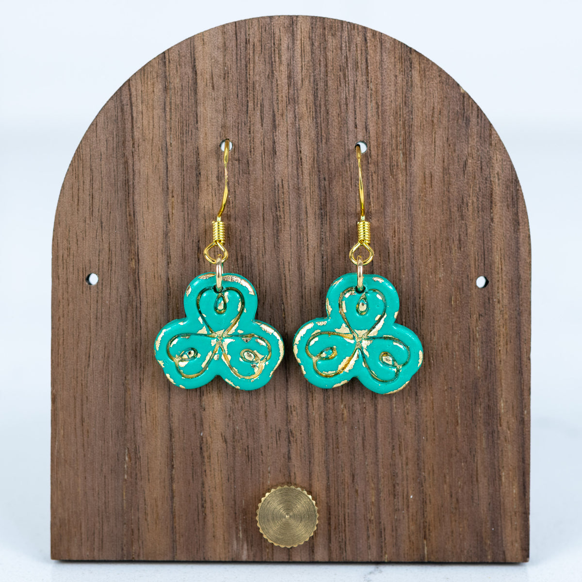 Teal clover earrings with gold accent detailing and gold hook hardware